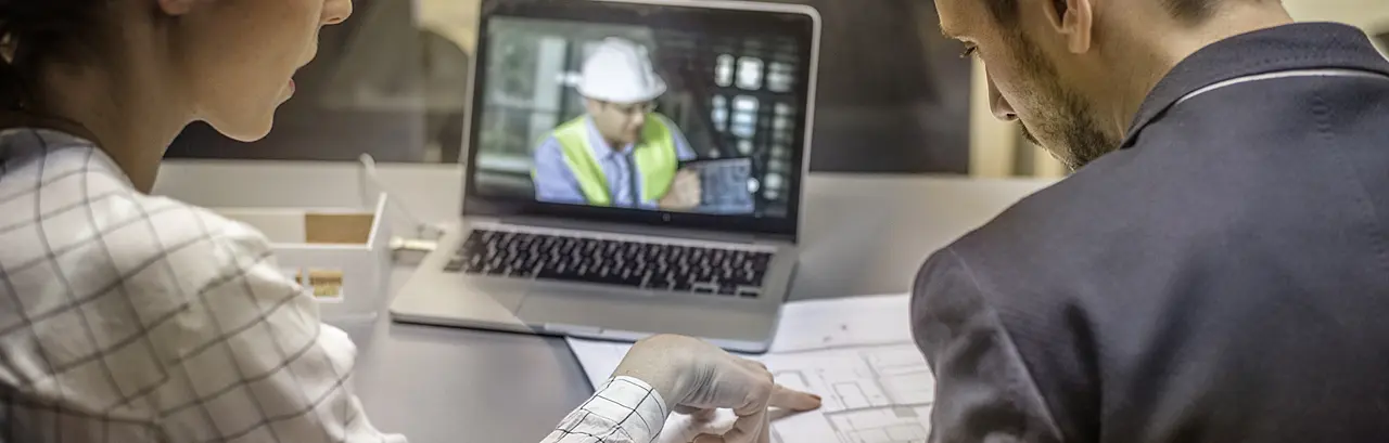 Two architects having video conference with an engineer colleague.