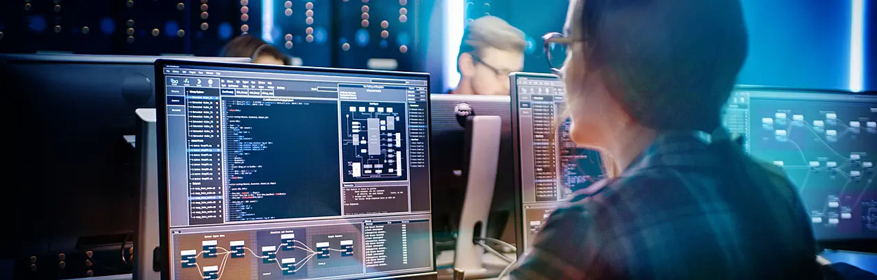 Smart Female IT Programer Working on Desktop Computer in Data Center System Control Room.