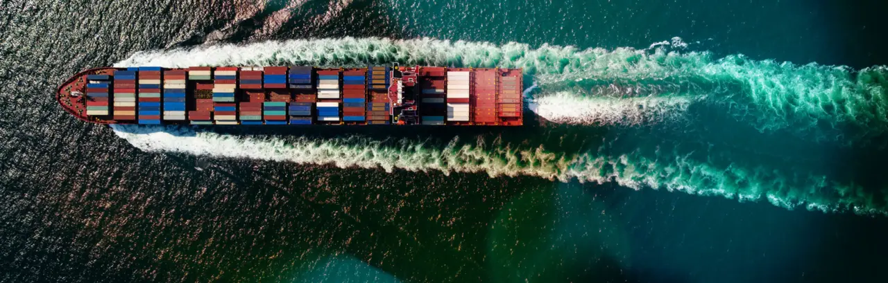 Cargo container ship sailing full speed in sea to import export goods and distributing products