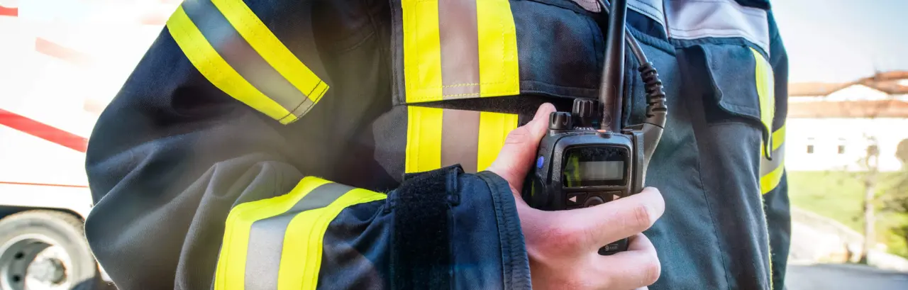 Firefighter using a walkie talkie, emergency call; all logos removed.