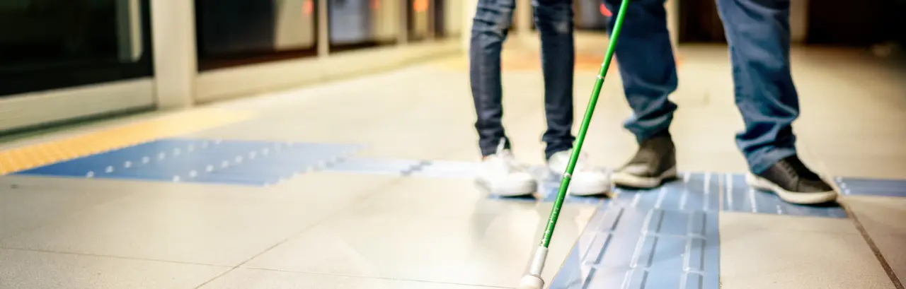 Low section of a blind father and a daughter at a subway station