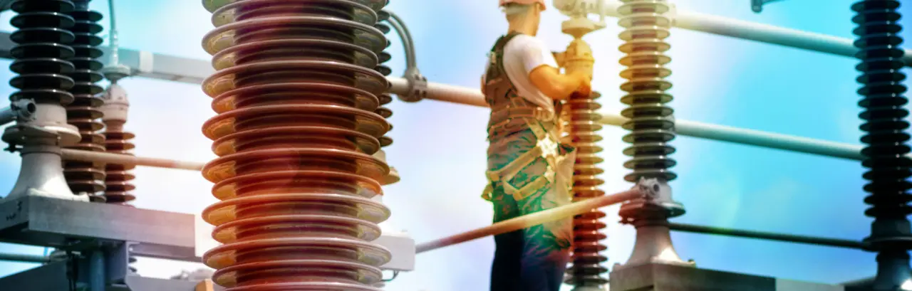 Construction worker with hadhat, protective workwear and safety belt working in power plant.