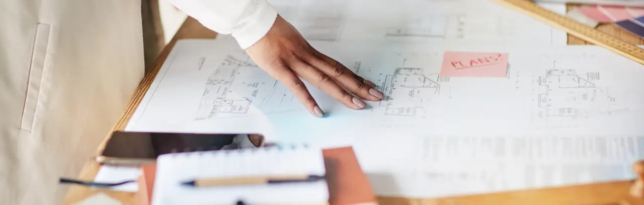 hand on an architectural blueprint