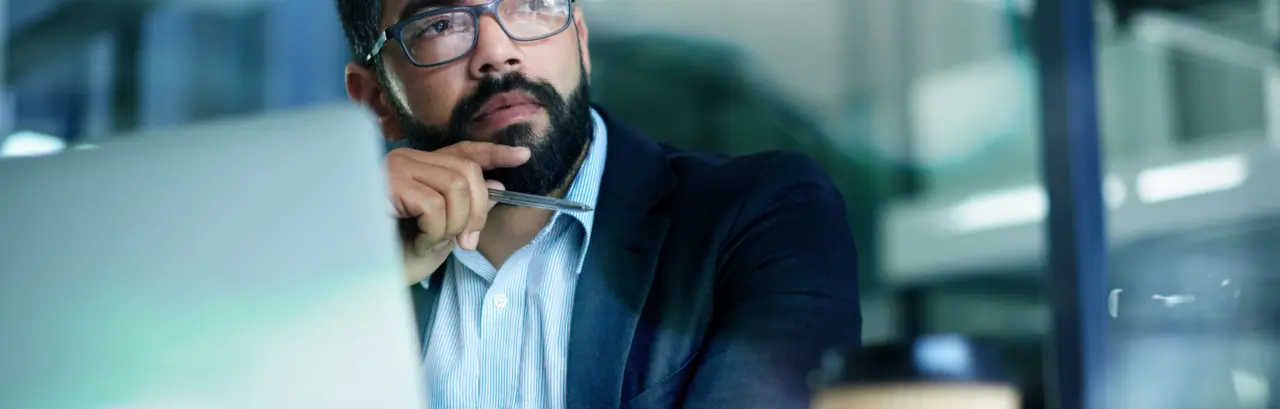 Shot of a mature businessman looking thoughtful while working on a laptop in an office