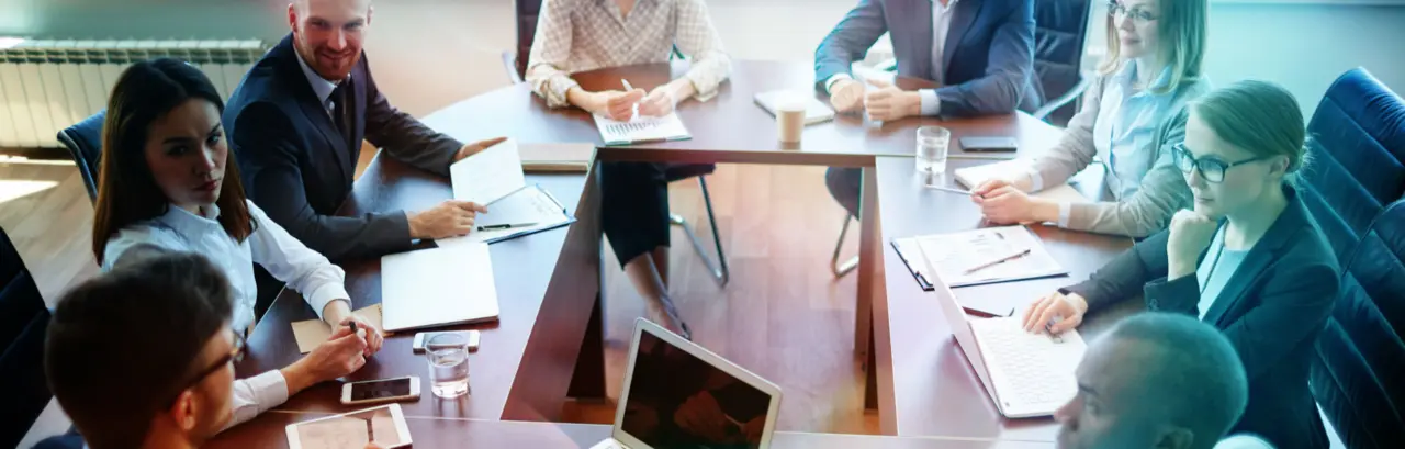 Businespeople at panel discussion in board room
