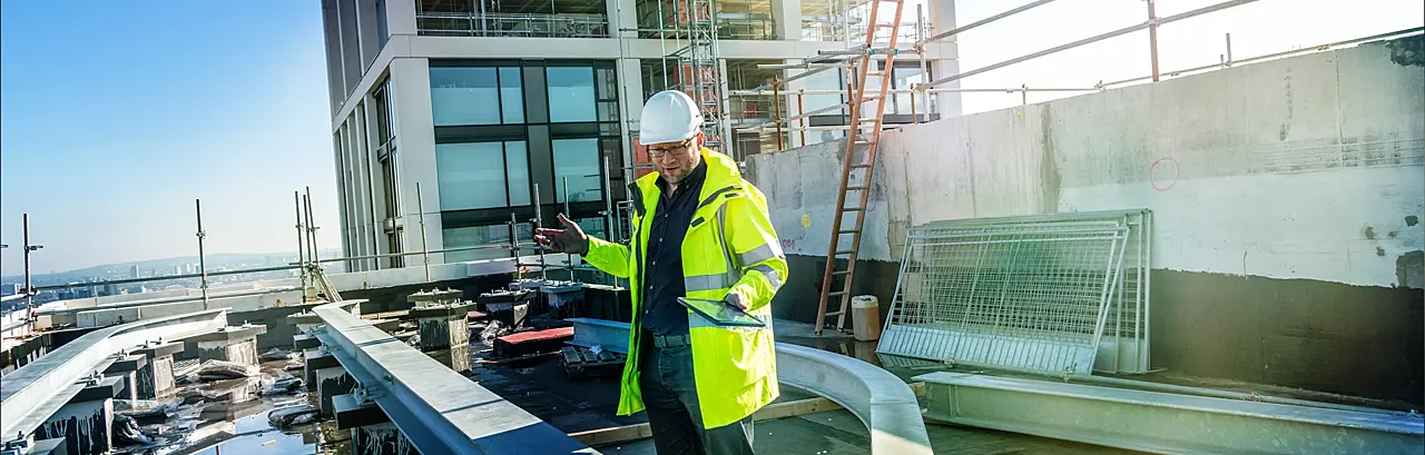 Architect inspects work at building site.