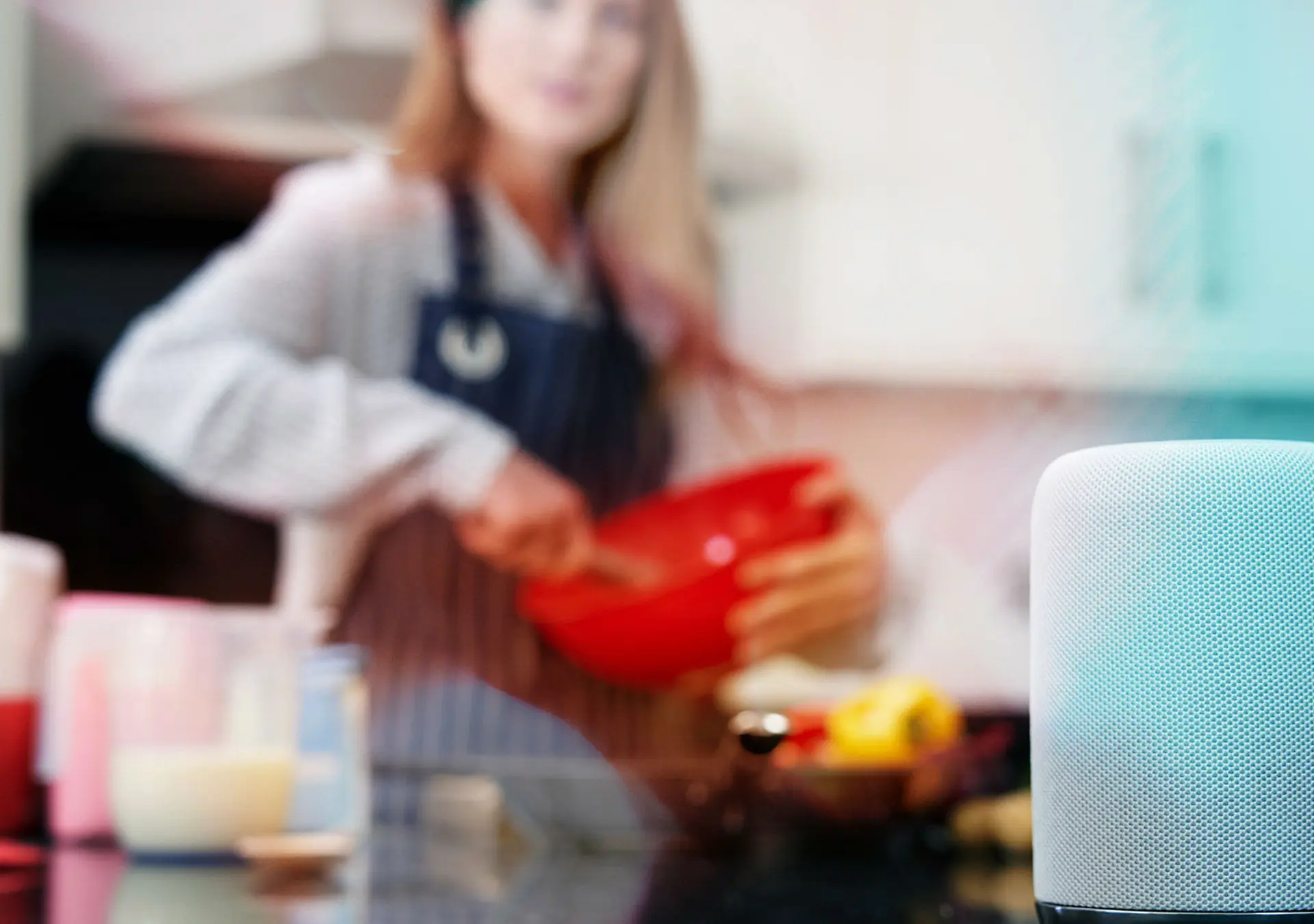 Woman Preparing Meal At Home Asking Digital Assistant Question