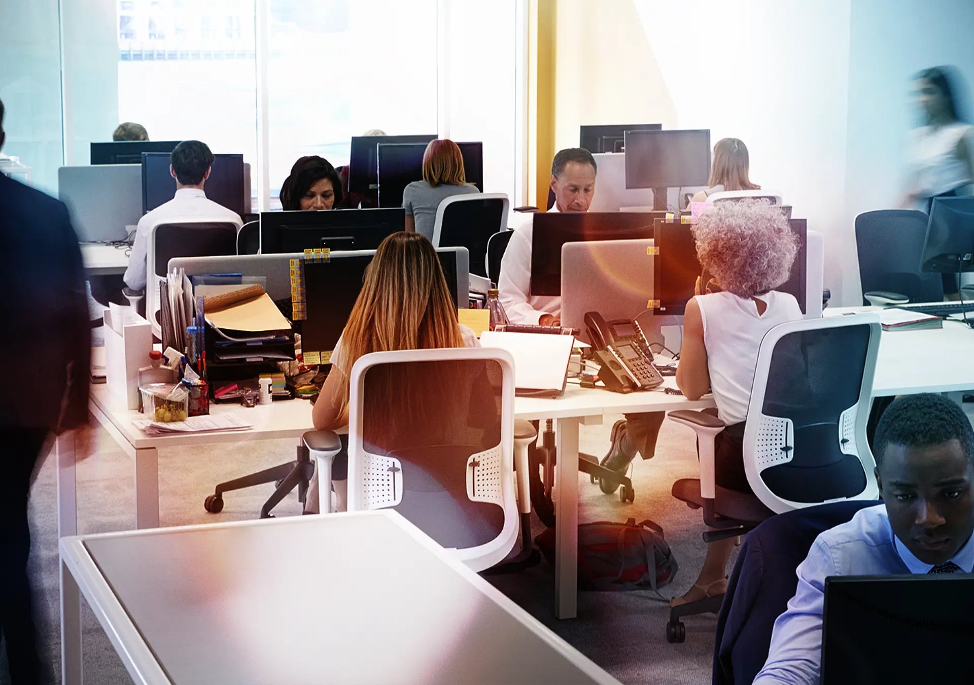 Man walking through a busy open plan office