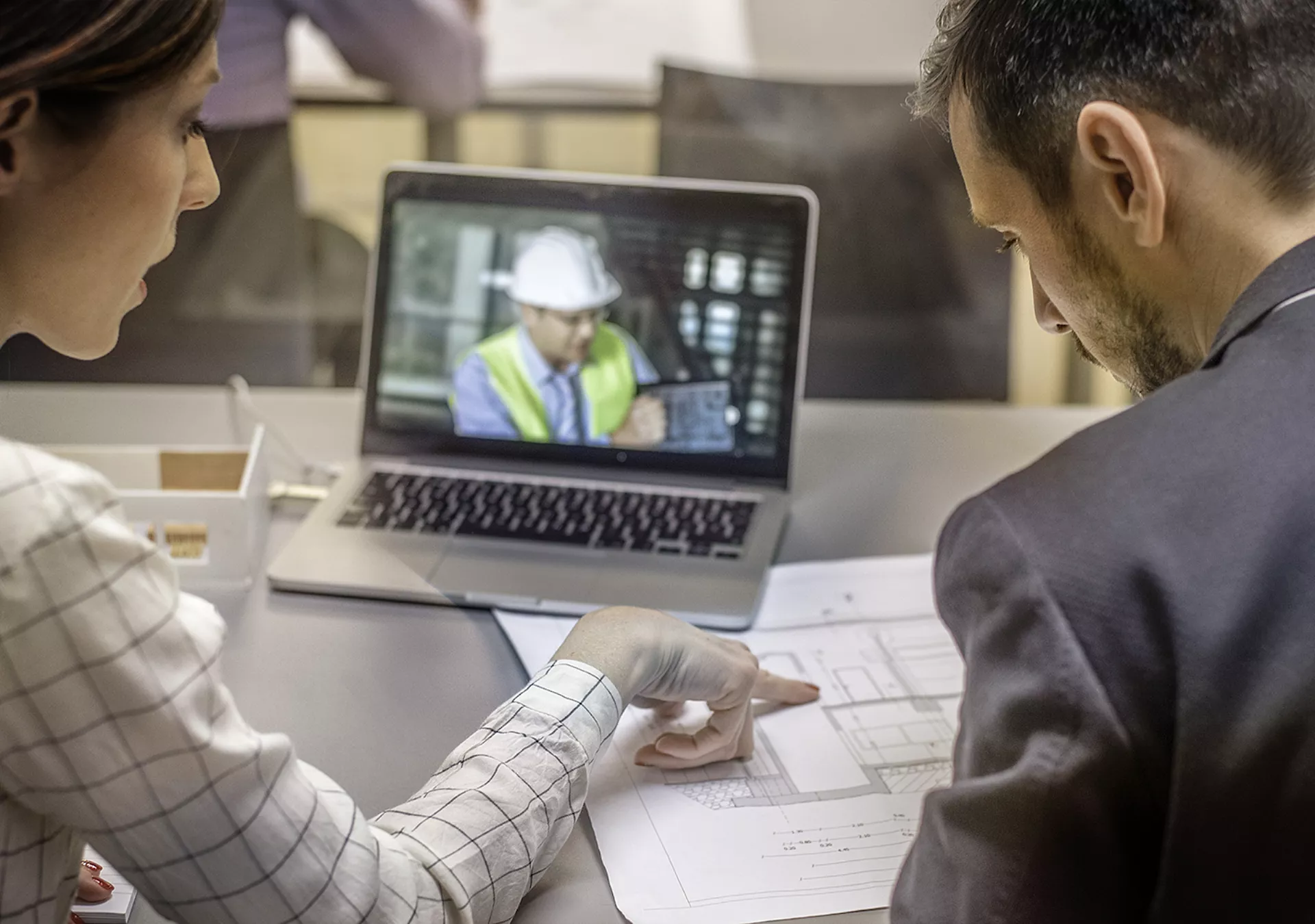 Two architects having video conference with an engineer colleague.