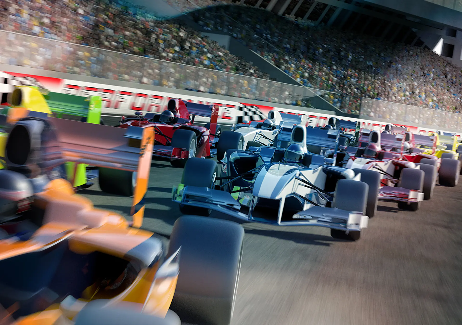 Racing cars speeding down around a bend in the track in front of a stadium filled with people.