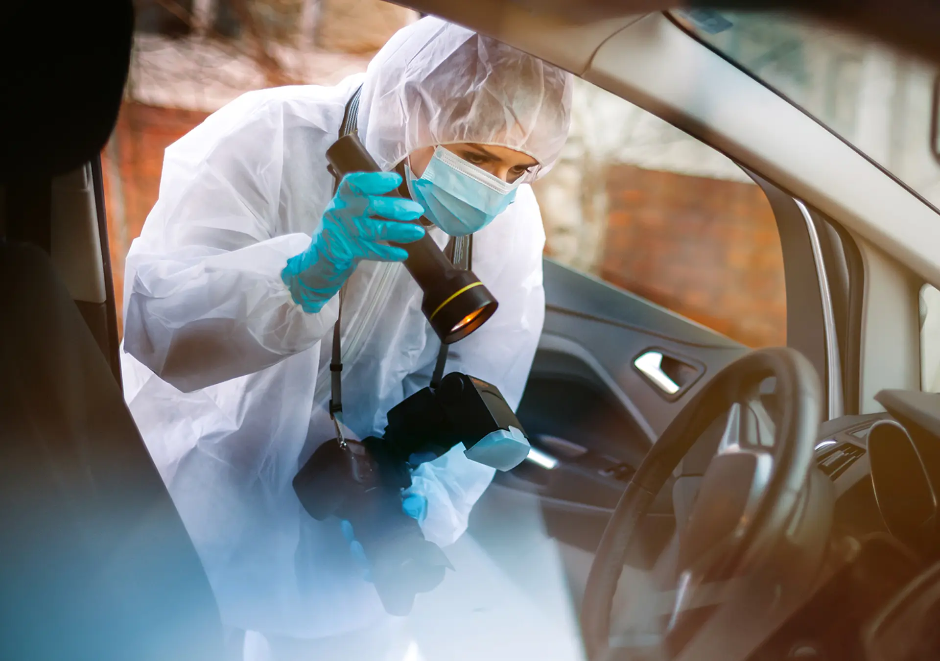 Person in PPE conducting a forensic investigation