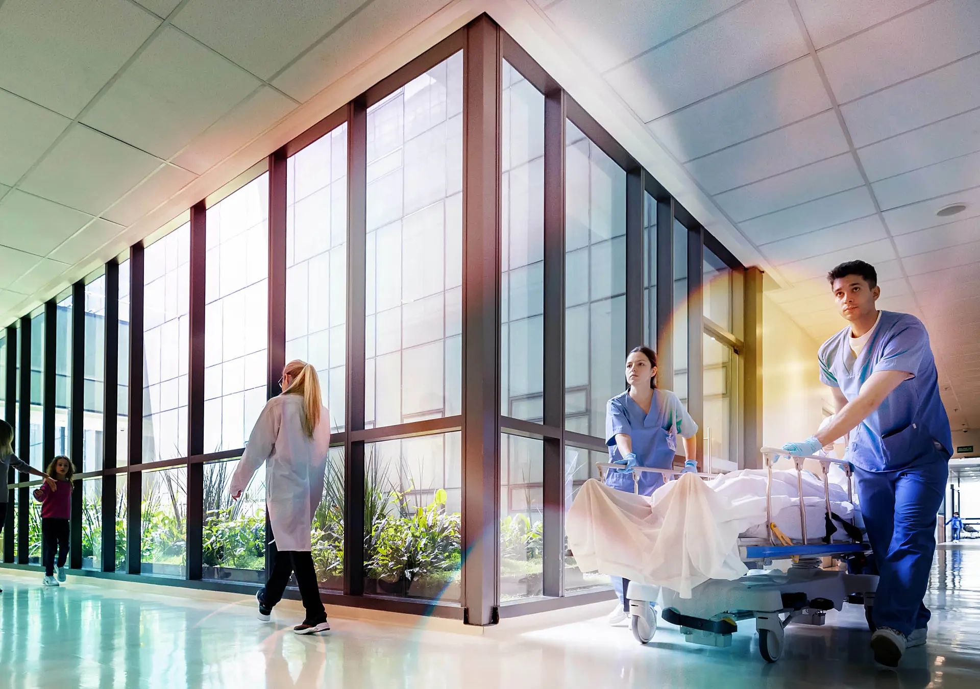 Latin American doctors assisting patients at the hospital and carrying one on a gurney