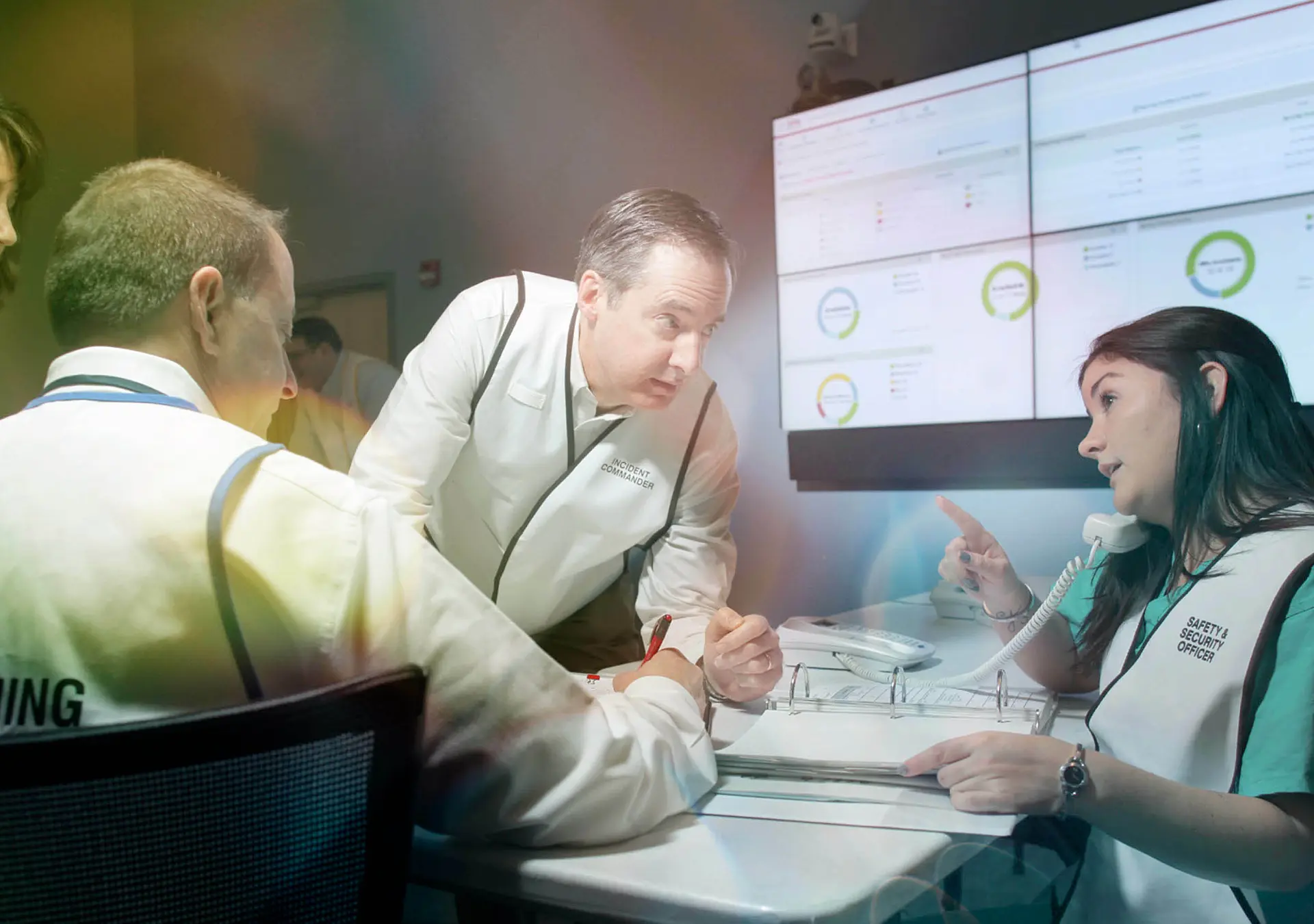 Group of people gathered around a table in a conference room setting.