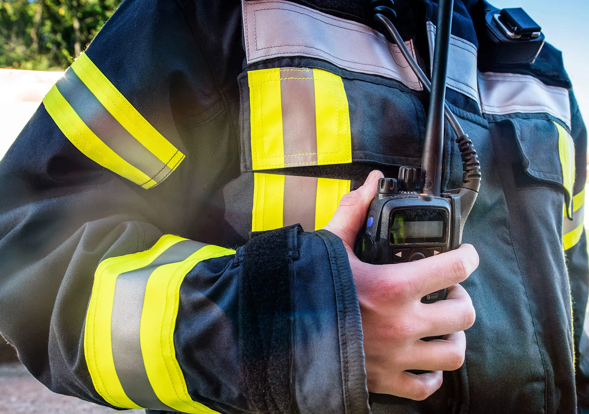 Firefighter using a walkie talkie, emergency call; all logos removed.