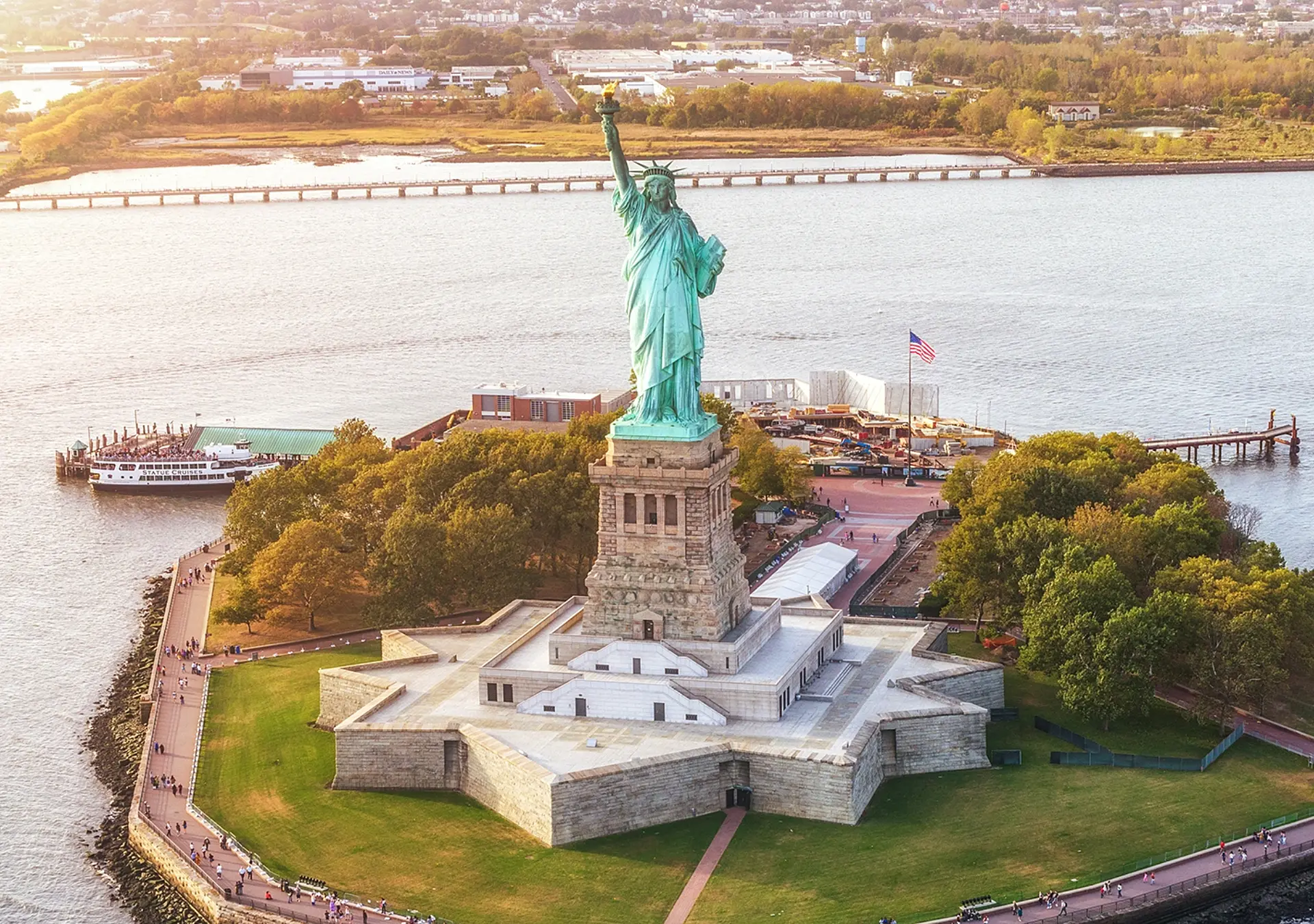 Aerial view of Statue of Liberty in Liberty Island and sunset. New York, USA