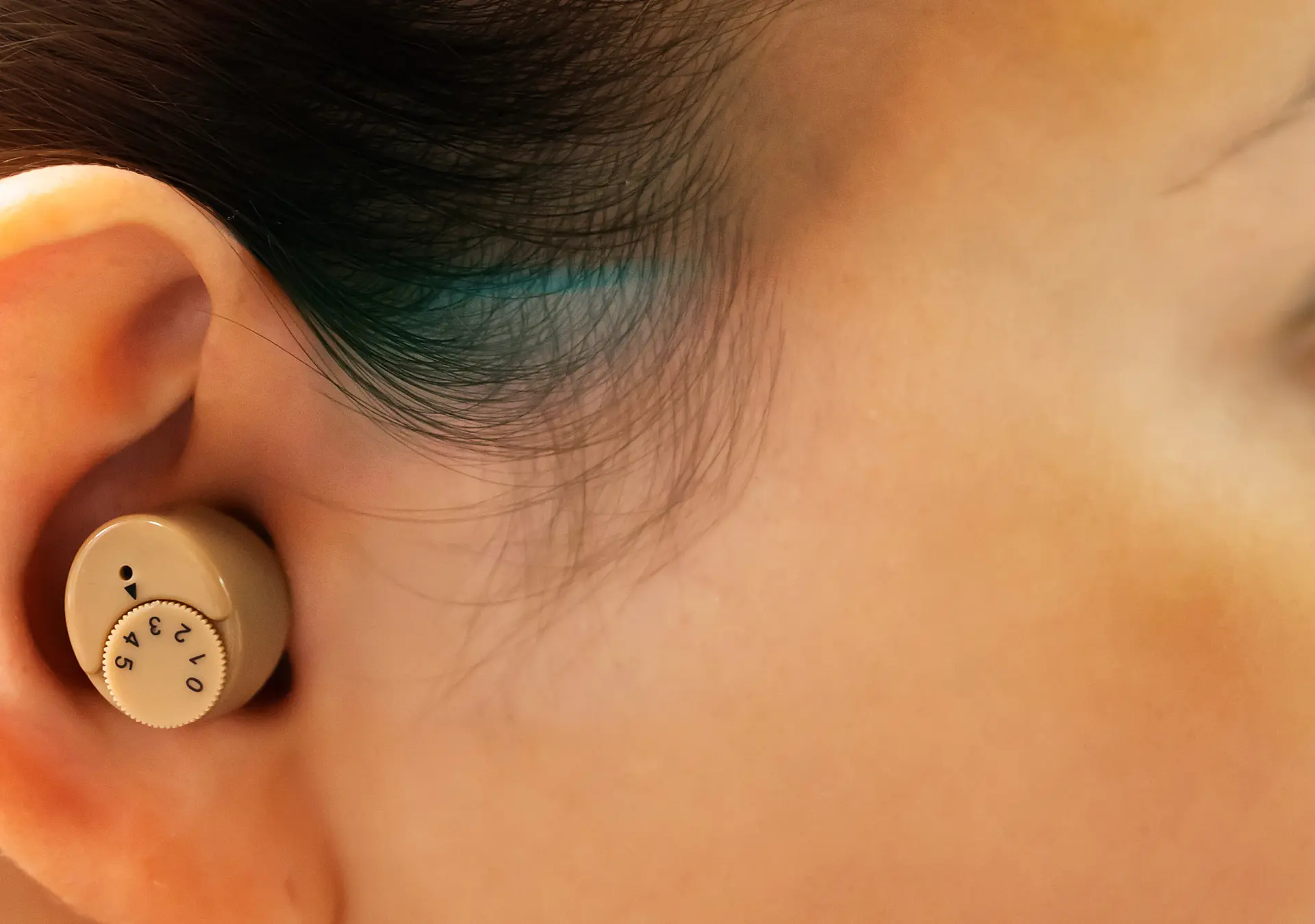 up close side image of woman with hearing aid