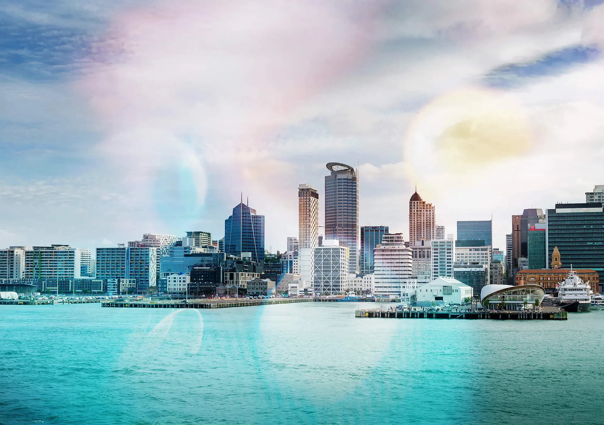 skyline of Auckland with city central business district and port cranes at cloudy noon