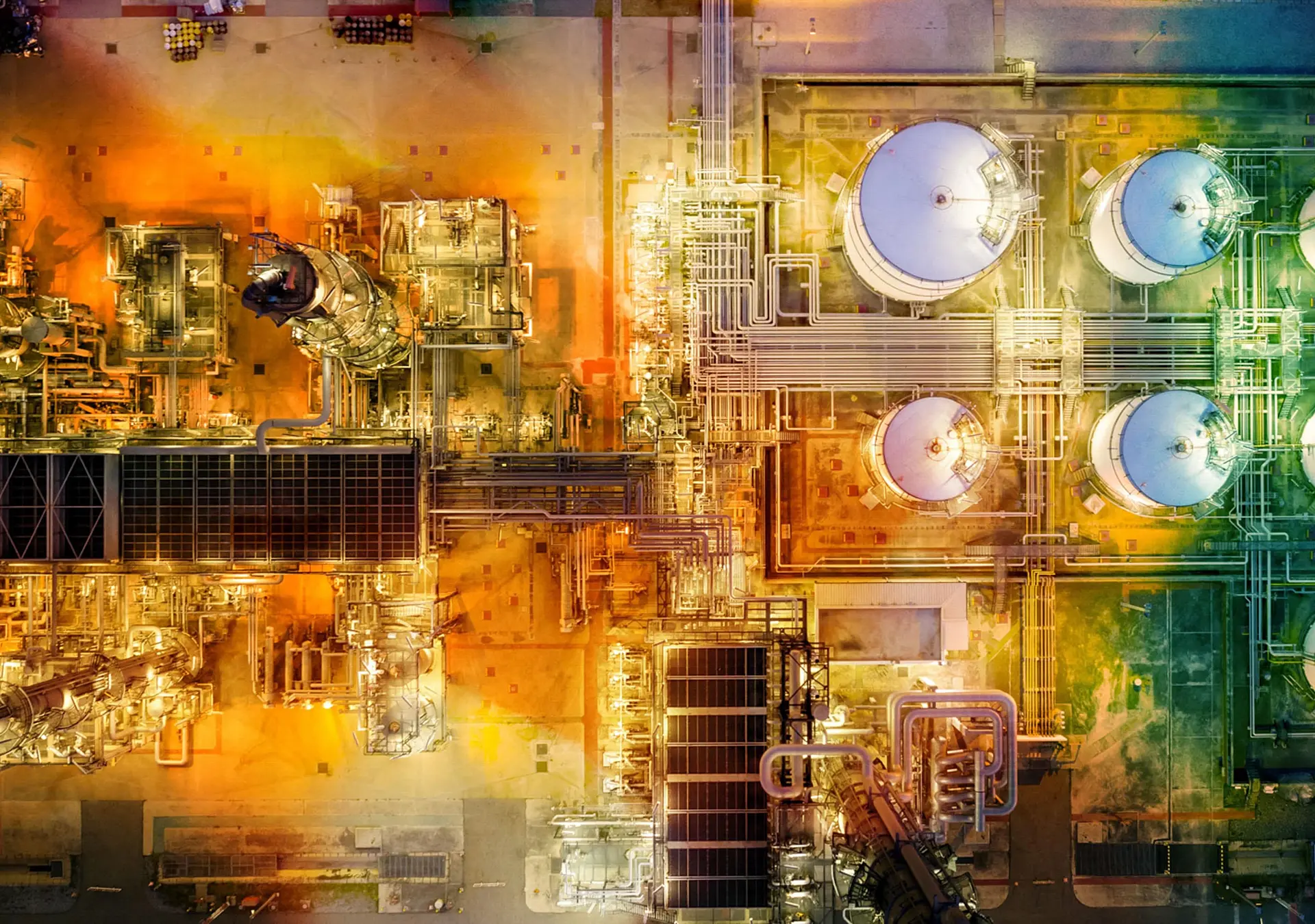 Oil refinery with storage tanks steel pipeline area at twilight aerial view from drone