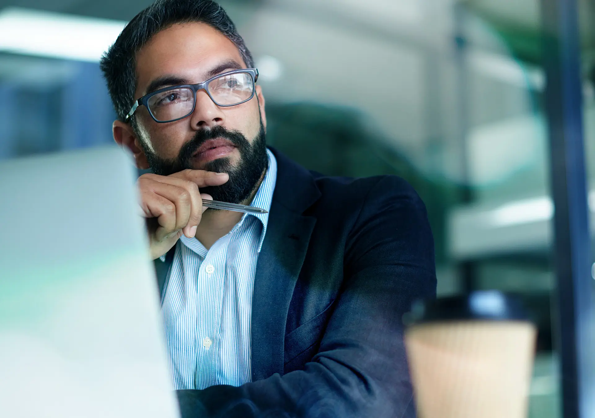 Shot of a mature businessman looking thoughtful while working on a laptop in an office