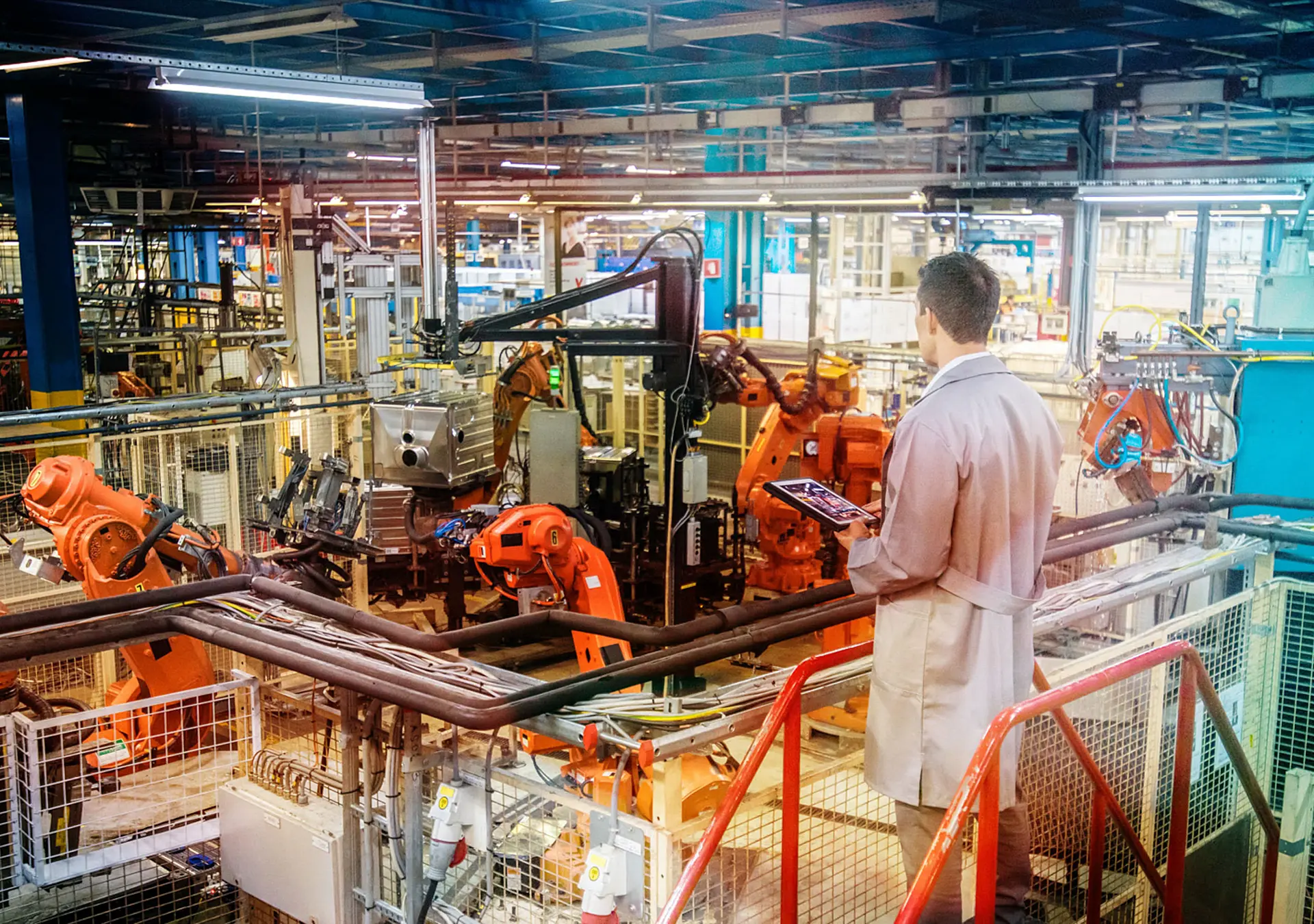 factory engineer inspecting work process robots operations in appliance manufacturing factory.