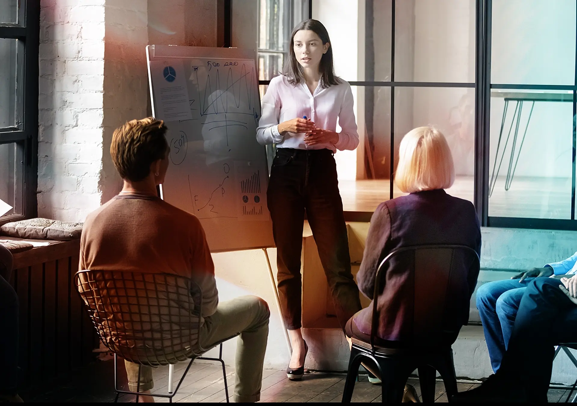 Confident lady business trainer coach leader give flip chart presentation consulting clients 