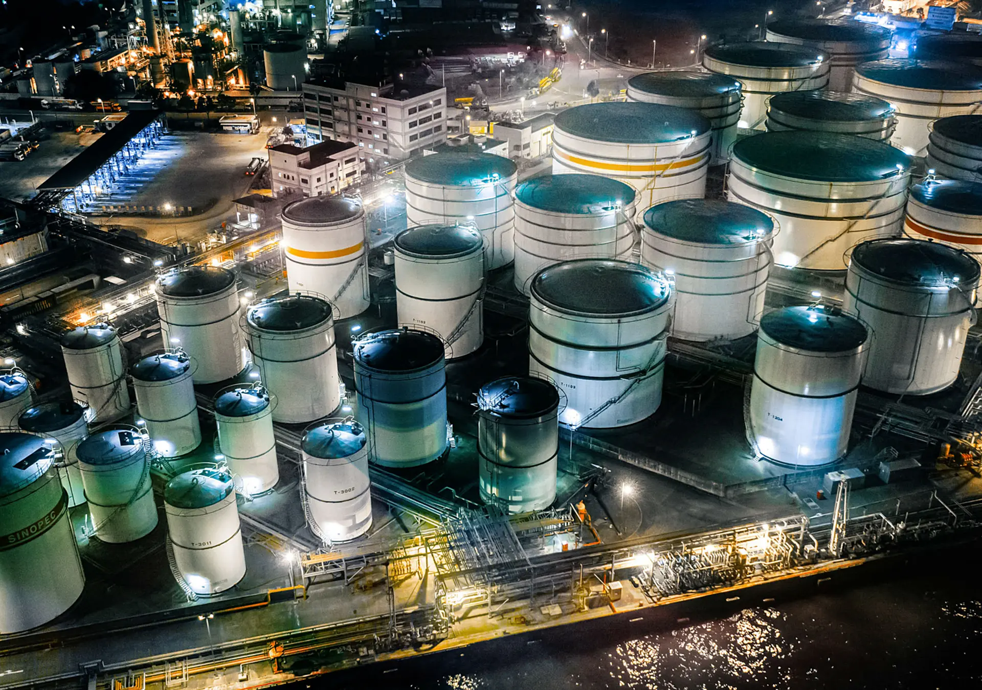 Storage tank of liquid chemical and petrochemical product tank, Aerial view at night.