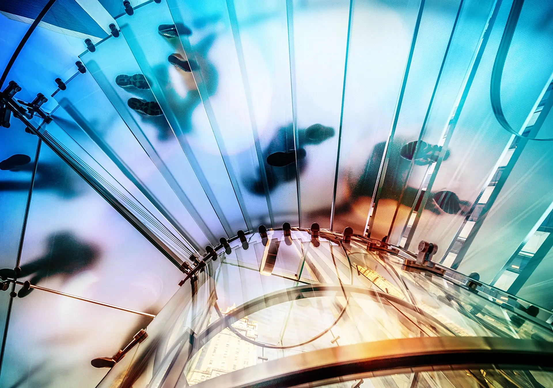 People walking on transparent glass spiral staircase in futuristic building, unrecognizable people.