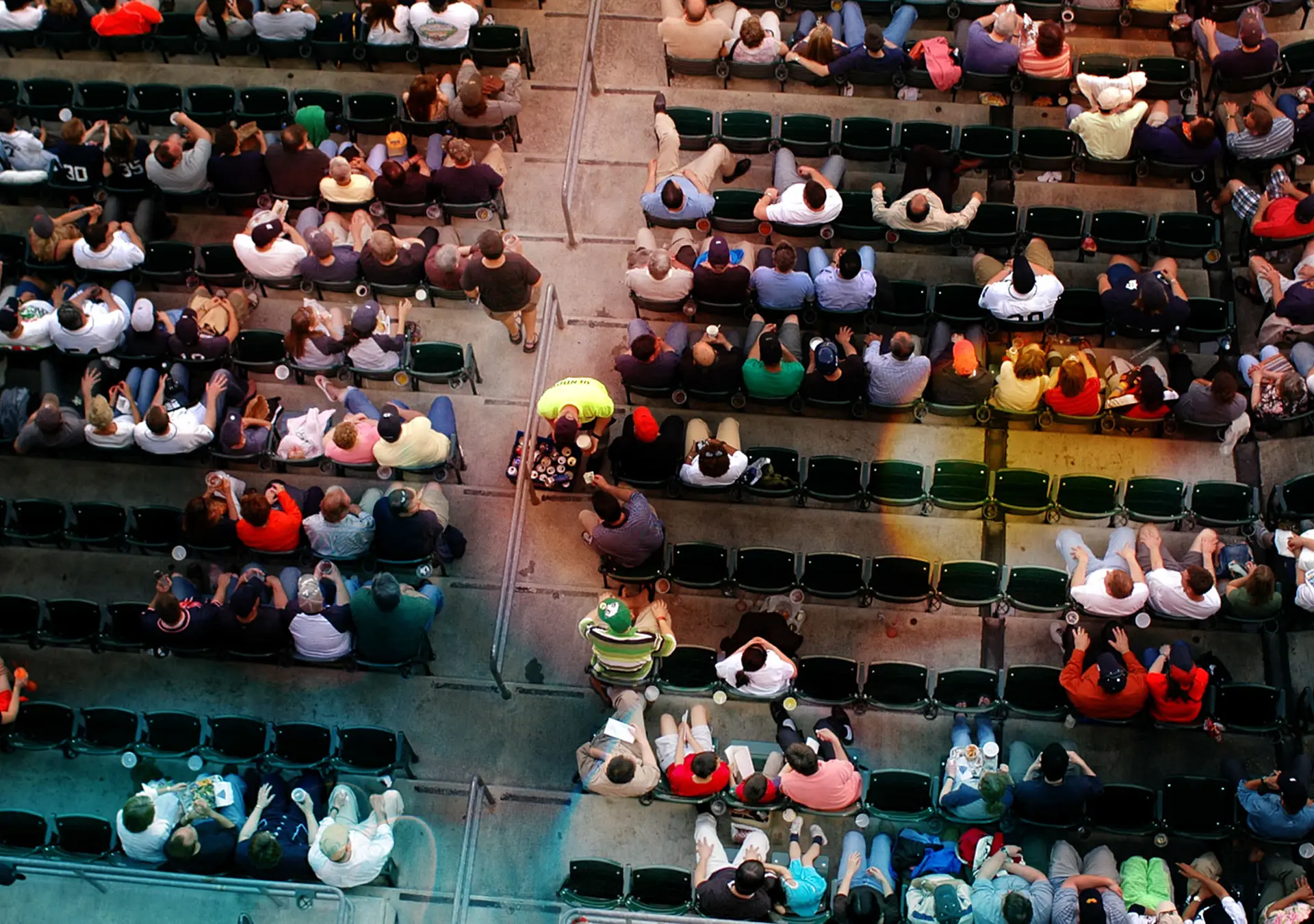 Shot from above a crowd watching a baseball game.