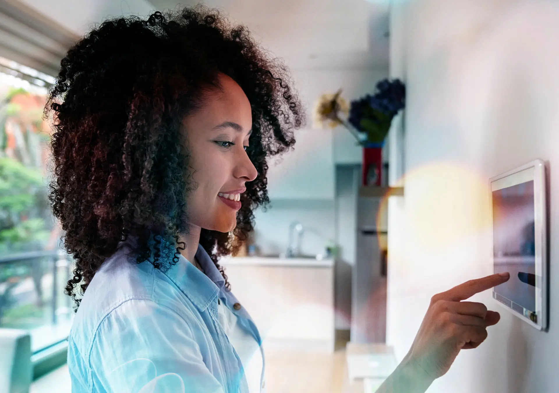woman setting up the intelligent home system on a tablet computer - technology concepts