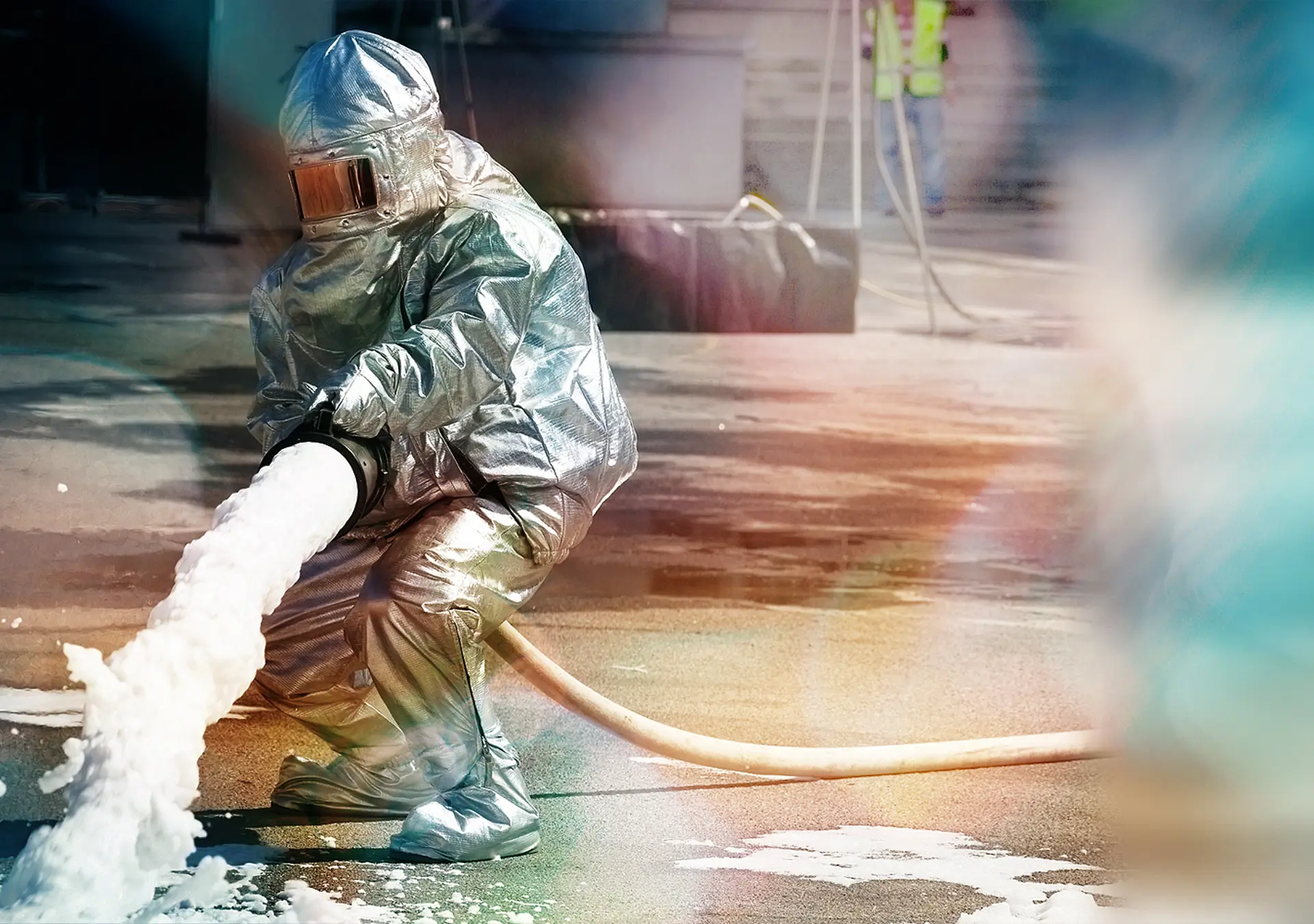 Save Download Preview Firefighter in action spraying fire with firefighting foam
