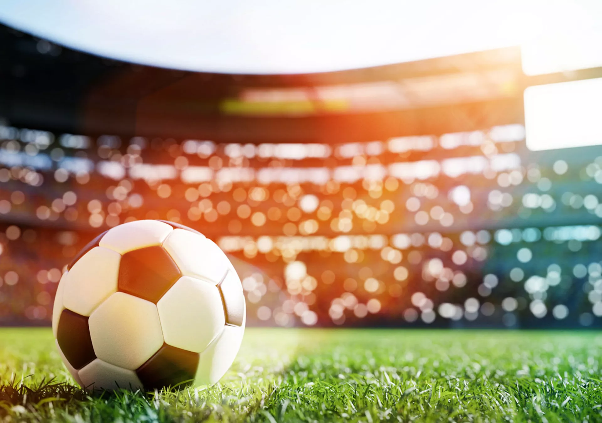 Football soccer ball on grass field on stadium.