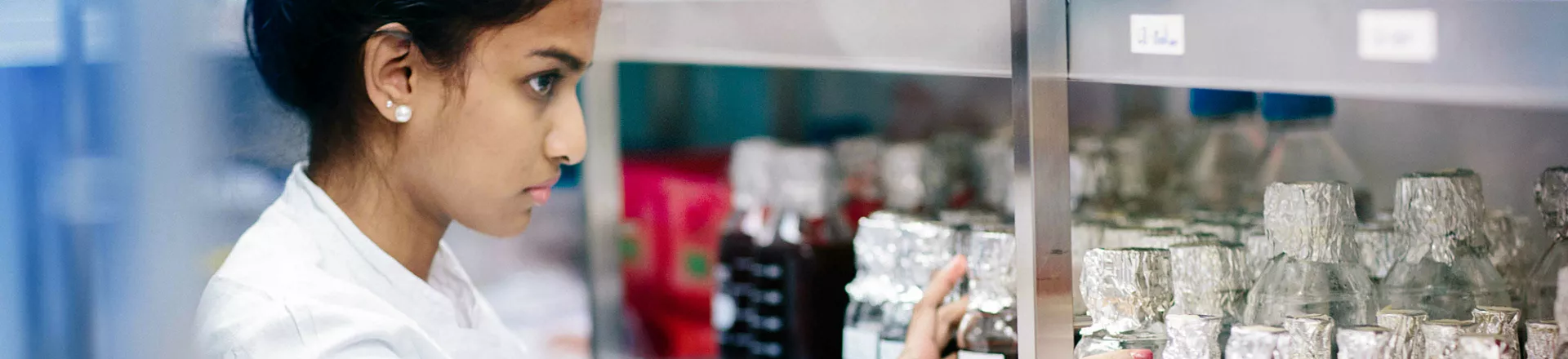 Young woman standing in a cold storage room from laboratory