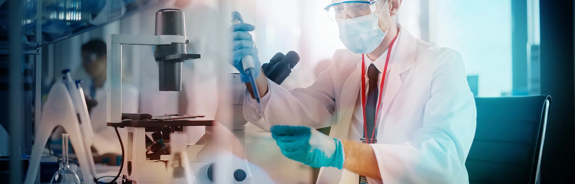 Scientist Wearing Face Mask Uses Micro Pipette Dropper to Mix Petri Dish Sample