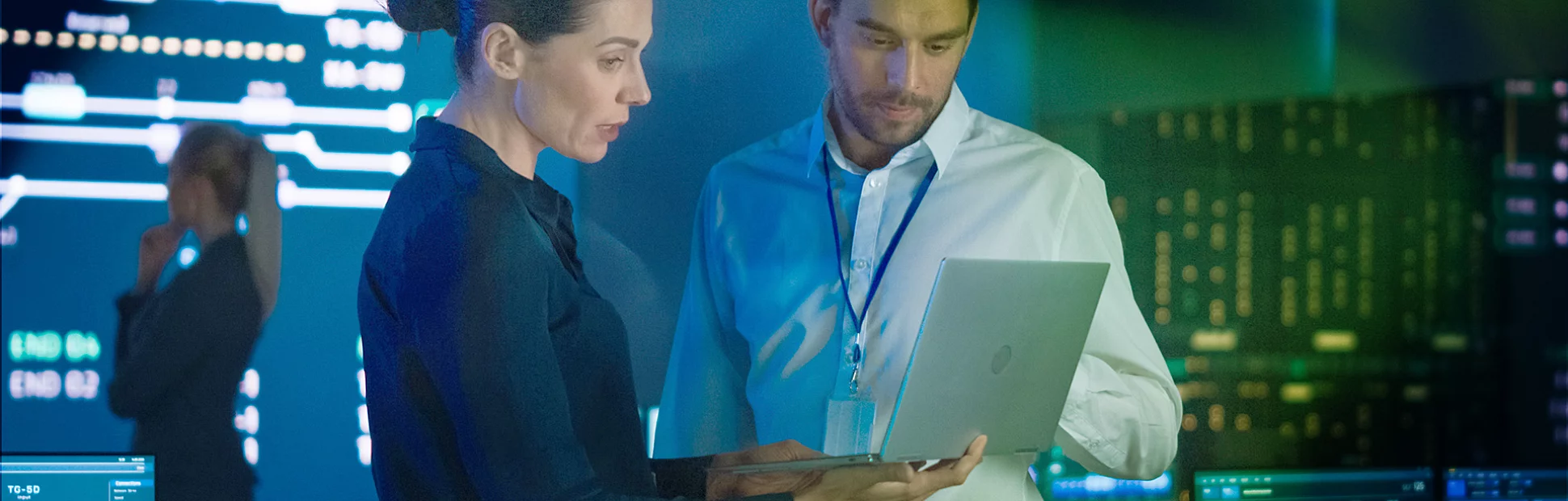 Project Leader and Chief Executive Discuss Data Shown on a Laptop.