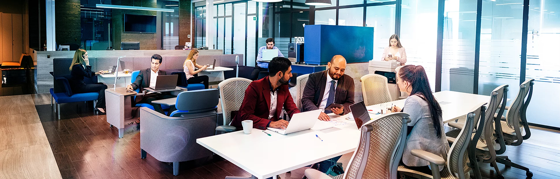 Business people hot desking in coworking office