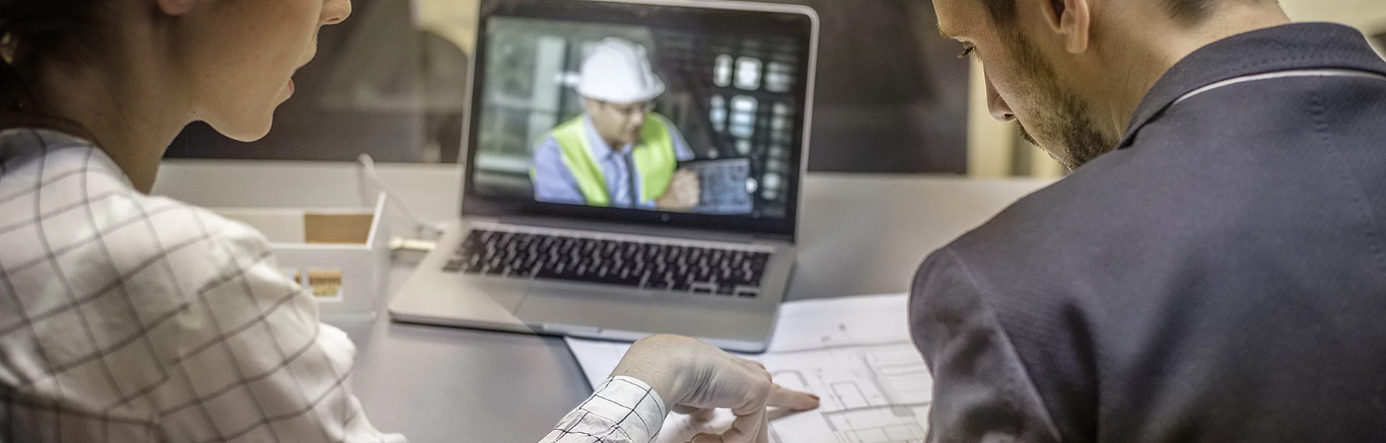 Two architects having video conference with an engineer colleague.