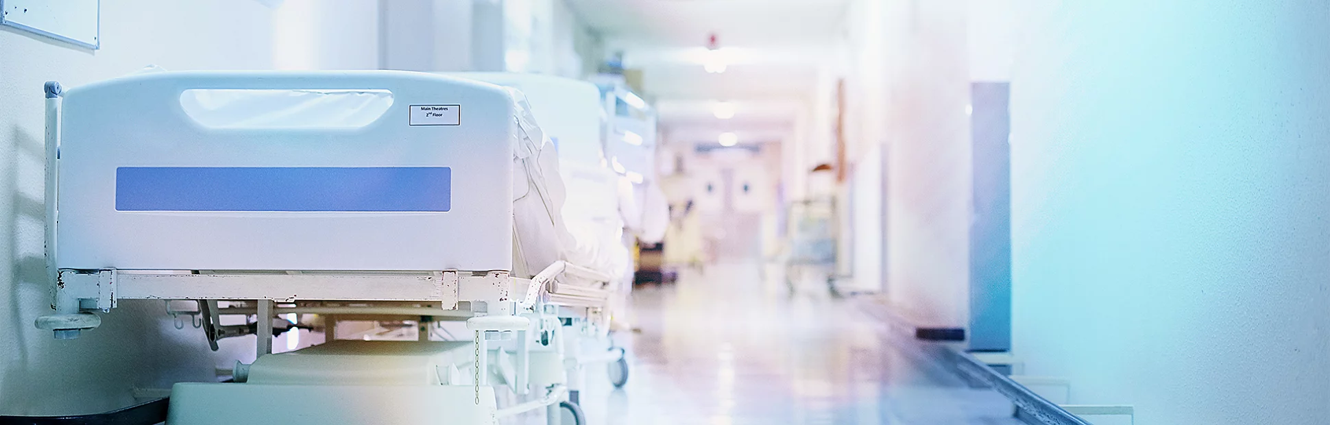 Shot of a hospital bed in an empty corridor of a modern hospital