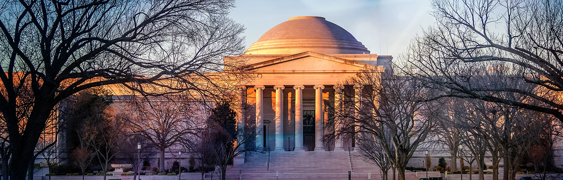 A view of the National Gallery of Art West Building at sunset in Washington, D.C.
