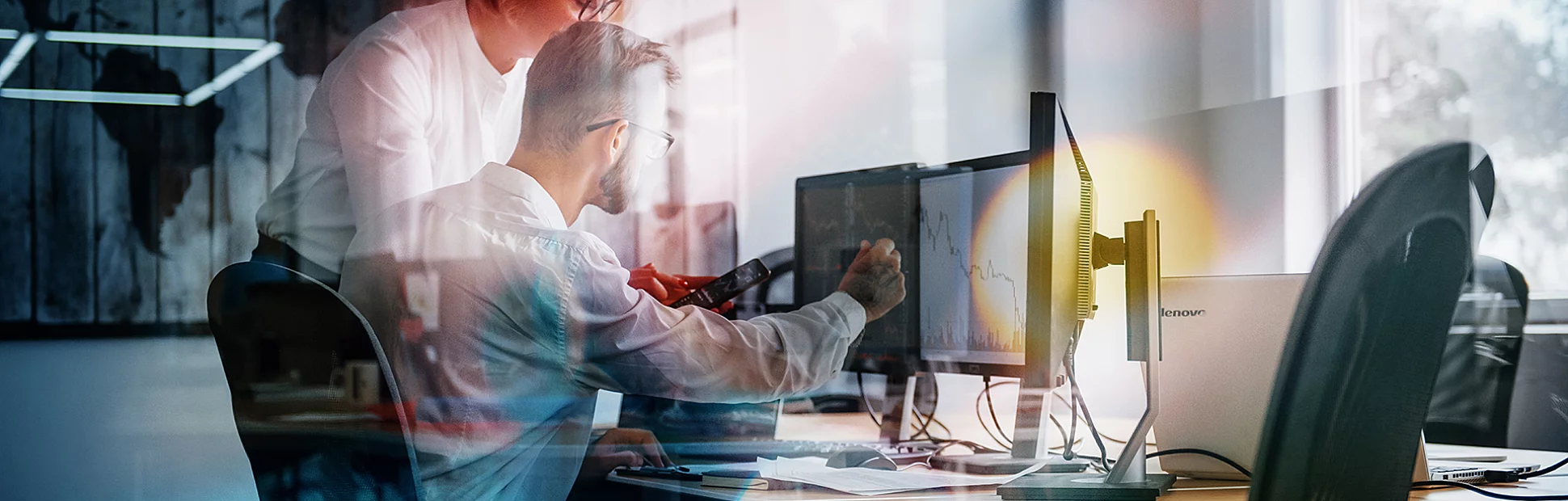 View of two employees in formal clothes working in the office.