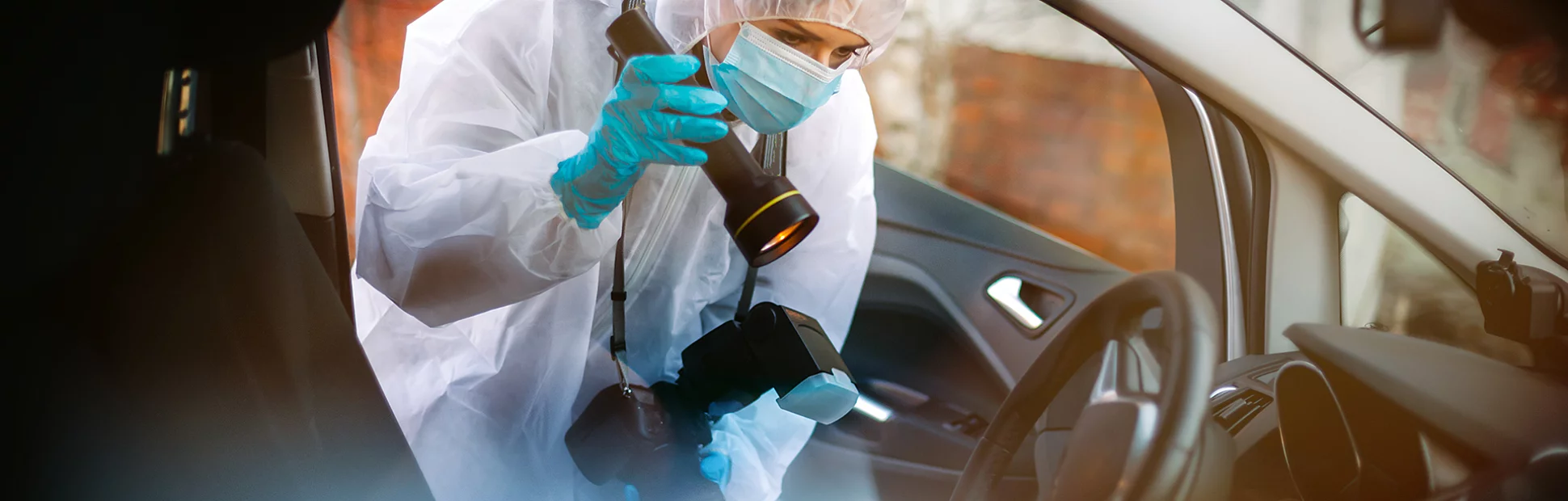 Person in PPE conducting a forensic investigation