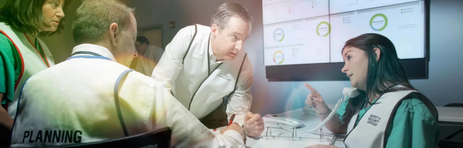 Group of people gathered around a table in a conference room setting.