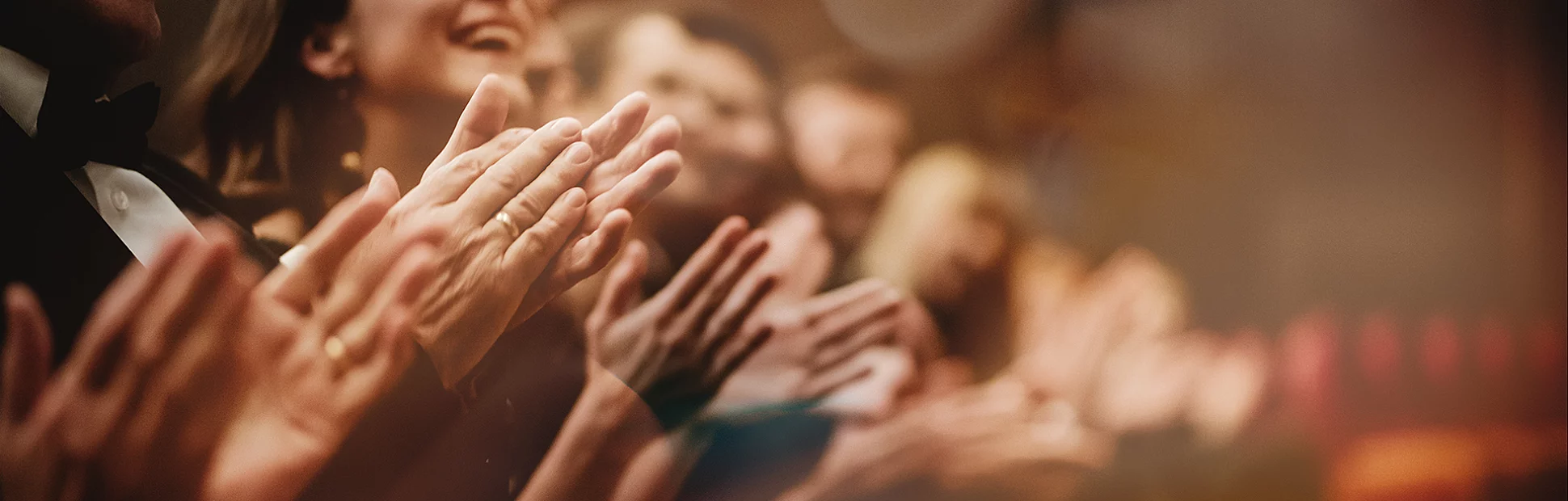 Excited audience clapping in the theater