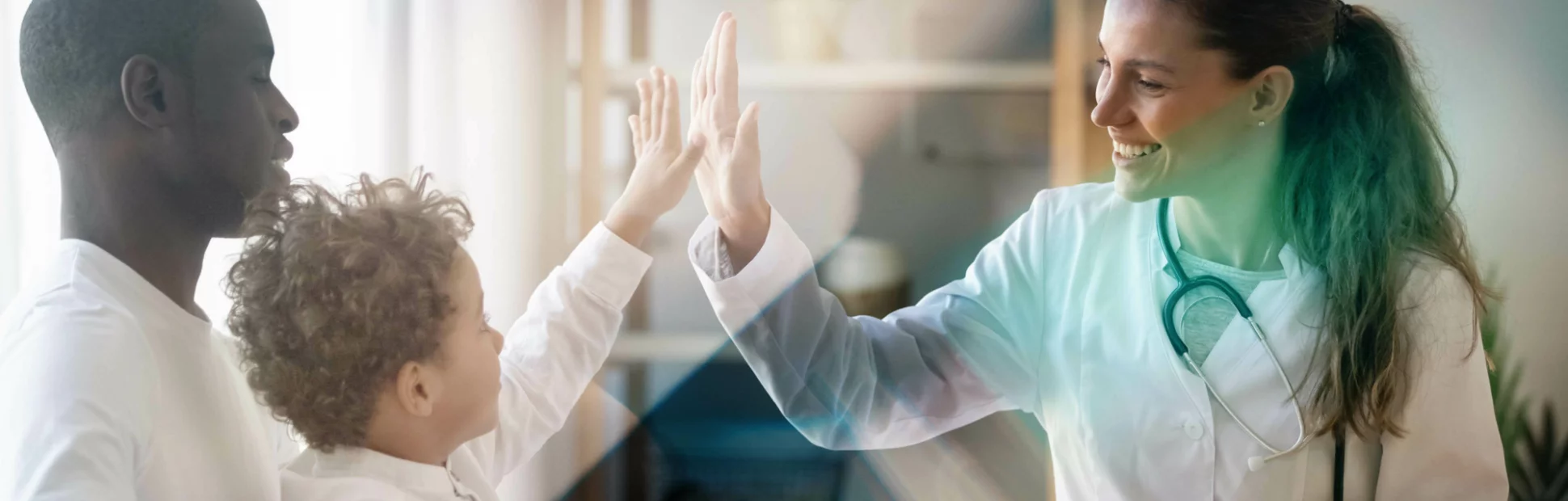 Happy little child boy gives high five to female doctor pediatrician at medical appointment