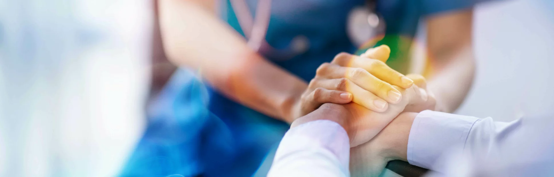 Cropped shot of a female nurse holding her senior patient's hand giving support