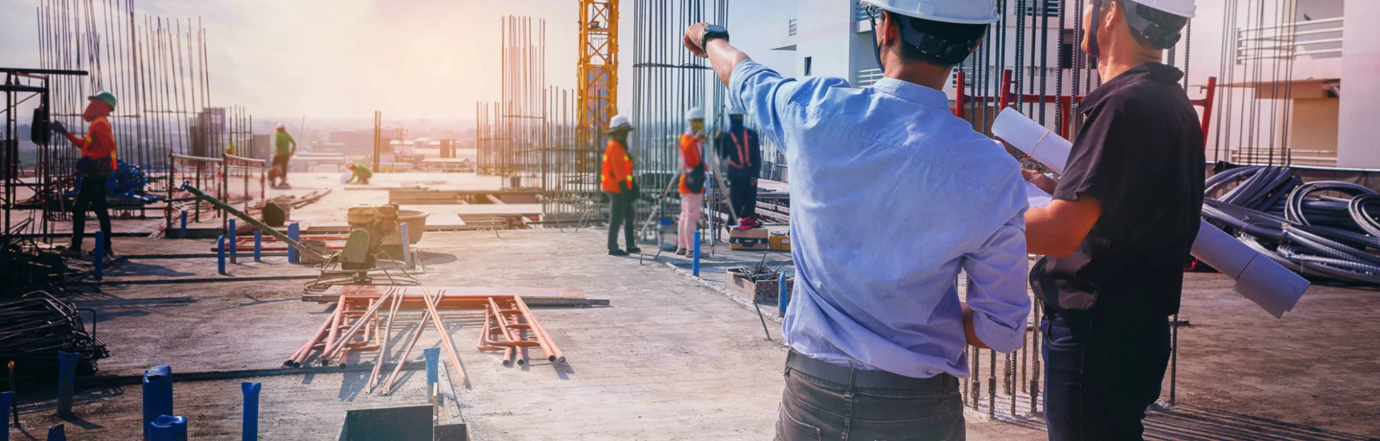civil architect engineer inspecting and working outdoors structure building site with blueprints.