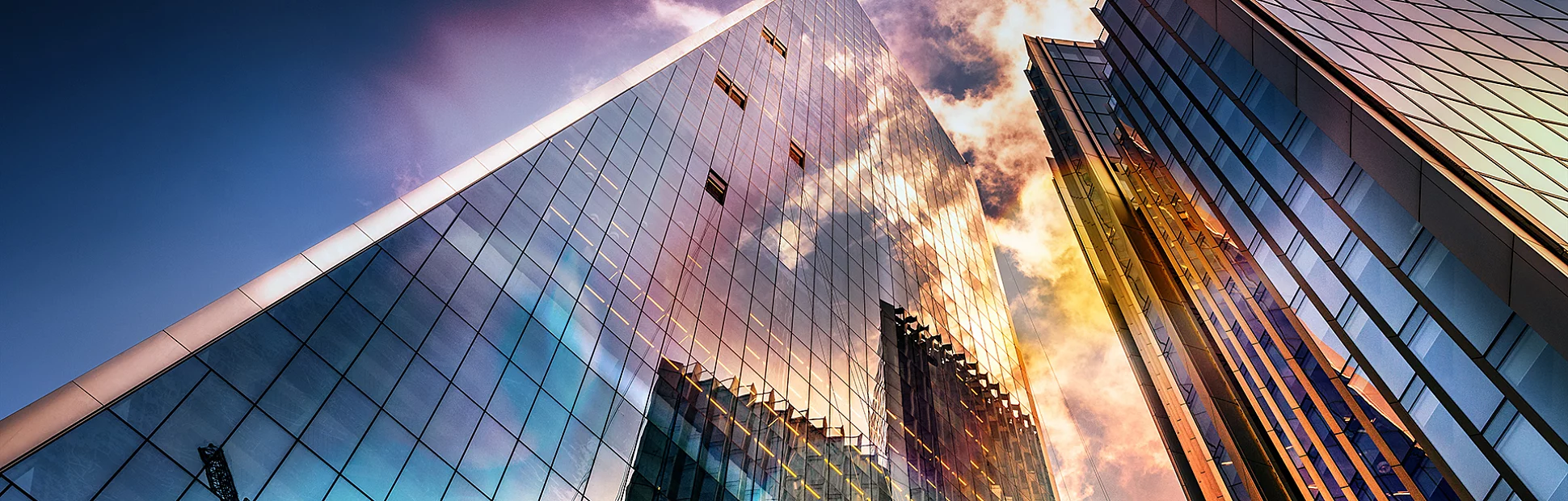 Bottom view of modern skyscrapers in business district in beautiful evening light at sunset