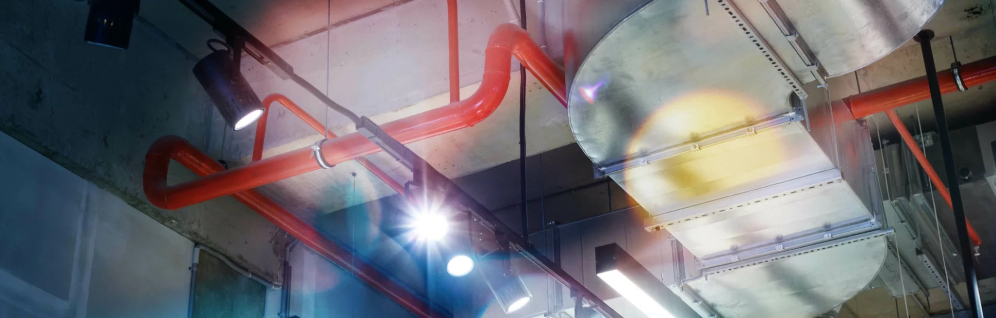 Industrial utilities under the ceiling. Ventilation, air conditioning, lighting and fire fighting