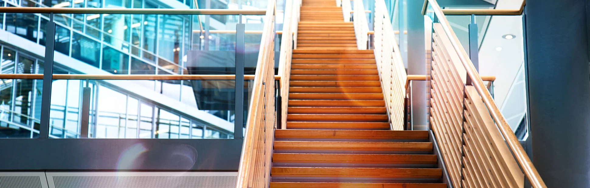 A wooden staircase in a modern office building