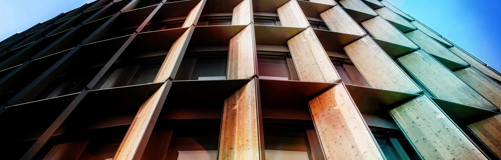 Looking up a business building with a wooden facade