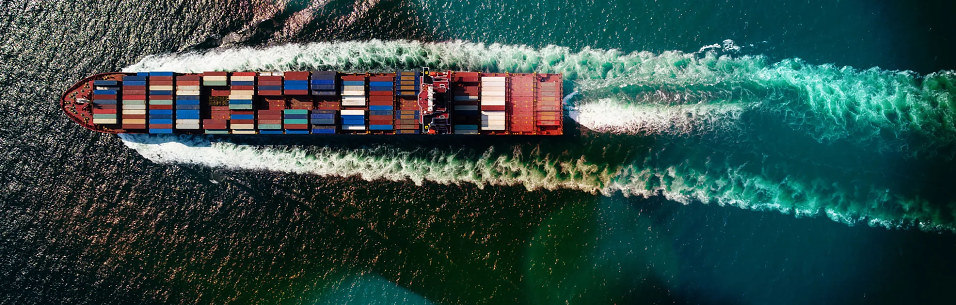 Cargo container ship sailing full speed in sea to import export goods and distributing products